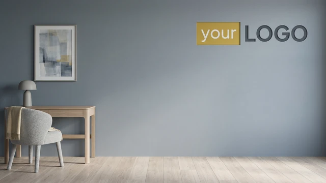 Minimal workspace with blue wall, wooden desk, upholstered chair, and mounted logo creating a calm professional video call background