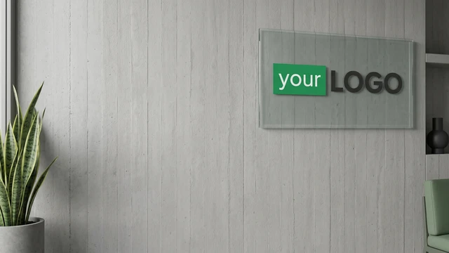 Vertical concrete wall with glass logo panel, plant, and minimal decor creating a modern professional video call background.
