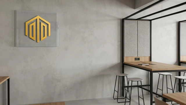 Minimal modern office setting with wooden desk, stools, and glass logo panel on a textured wall, suitable for professional video calls and virtual meetings.